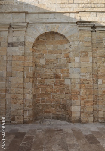 The niche is made in an old building of a rounded shape. 
