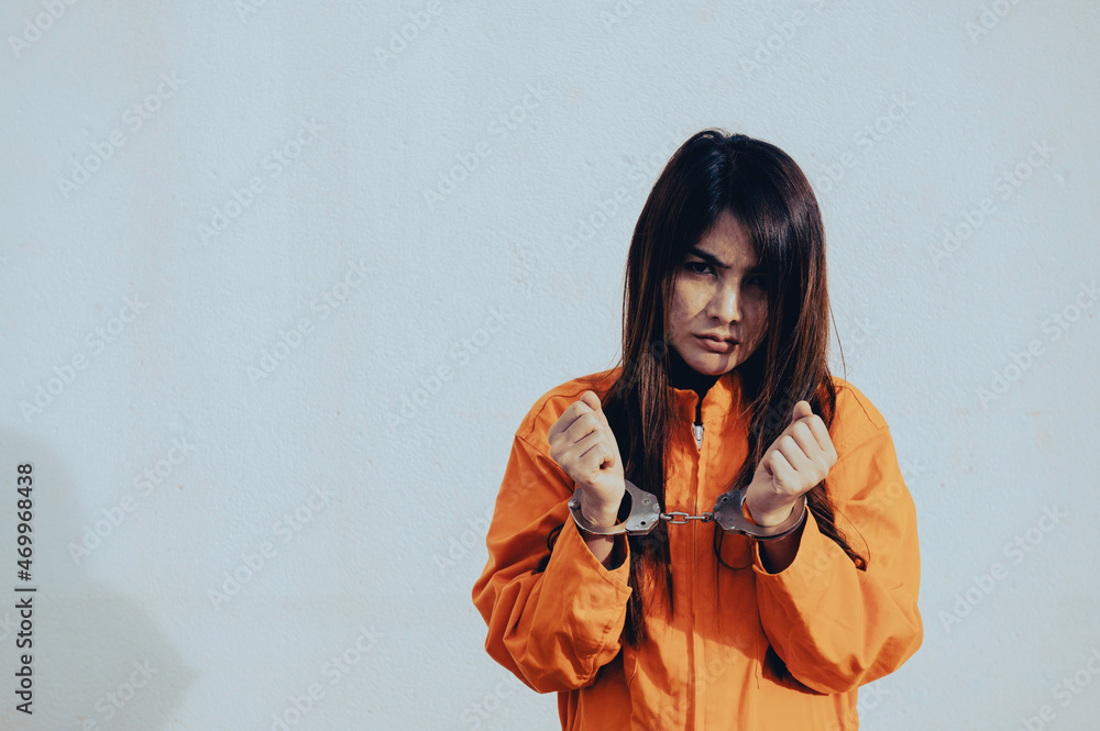 Prisoner in orange robe concept,Portrait of asian woman in Prison uniforms on white background, Prisoner in orange robe concept,Portrait of asian woman in Prison uniforms on white background,