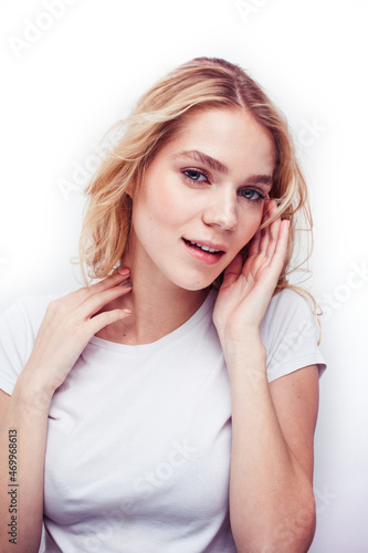 young pretty stylish blond hipster girl posing emotional isolated on white background happy smiling cool smile, lifestyle people concept