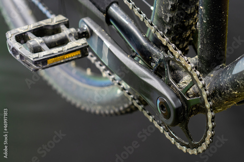 Beautiful modern black bike in the workshop. Repair and maintenance of mountain bikes. Pedals close-up.