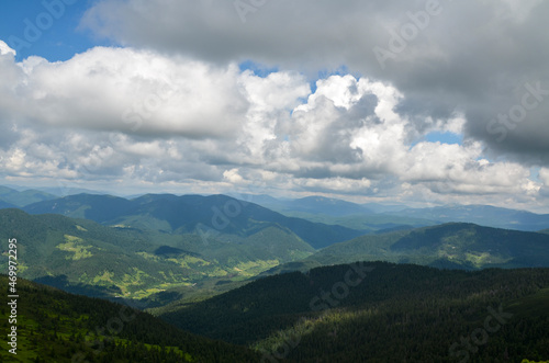 Landscape with mountains and hills covered forest with cloudy sky. Carpathians, Ukraine