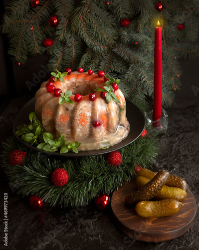 Homemade delicious jelly meat on the festive Christmas table. Perfect cold meat, aspic, galantine with carrots. Russian cuisine