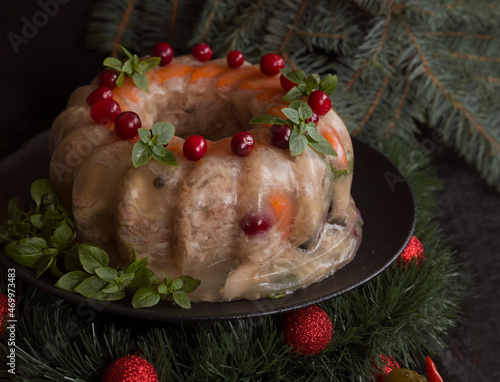Homemade delicious jelly meat on the festive Christmas table. Perfect cold meat, aspic, galantine with carrots. Russian cuisine