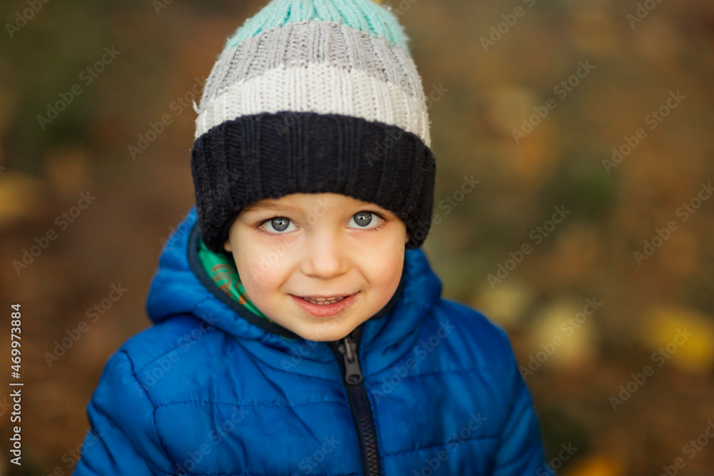 Portrait of small boy with blue eyes in winter hat and blue jack Portrait of small boy with blue eyes in winter hat and blue jack