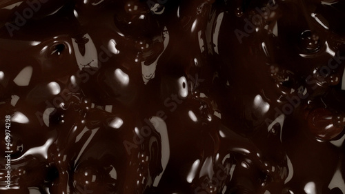 Closeup of splashing dark melted chocolate