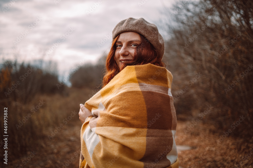 Young beautiful happy girl posing with knitted scarf and stylish trench coat. Smiling woman looking at camera during autumn season. Autumn fashion clothes Young beautiful happy girl posing with knitted scarf and stylish trench coat. Smiling woman looking at camera during autumn season. Autumn fashion clothes