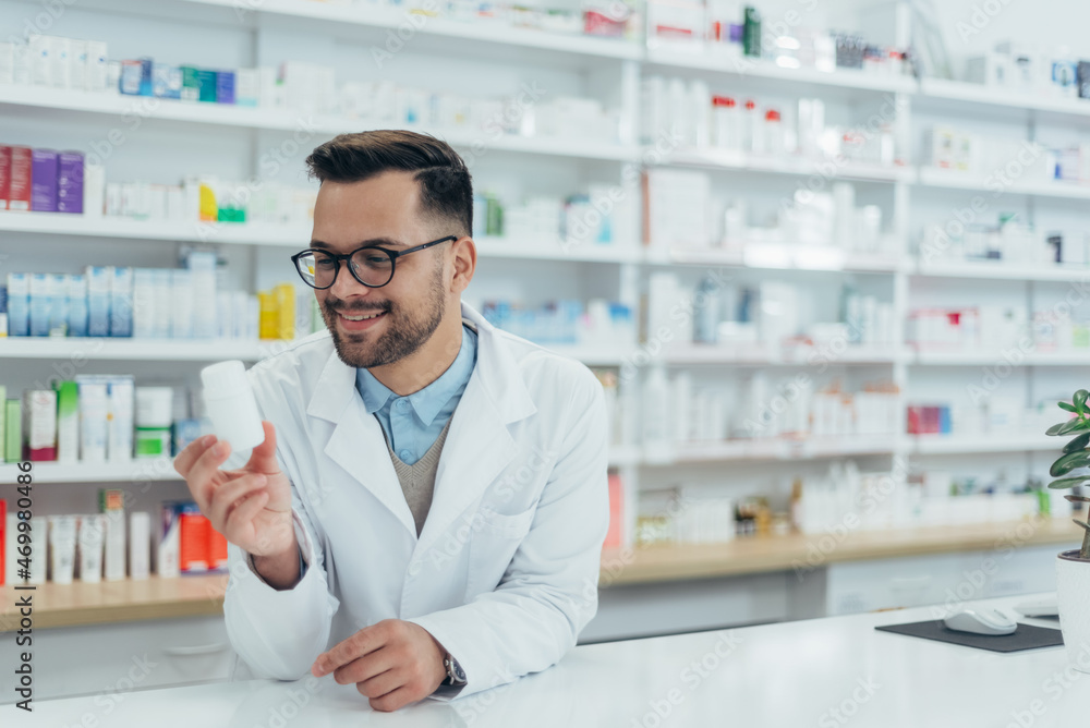 Portrait of a handsome pharmacist working in a pharmacy Portrait of a handsome pharmacist working in a pharmacy