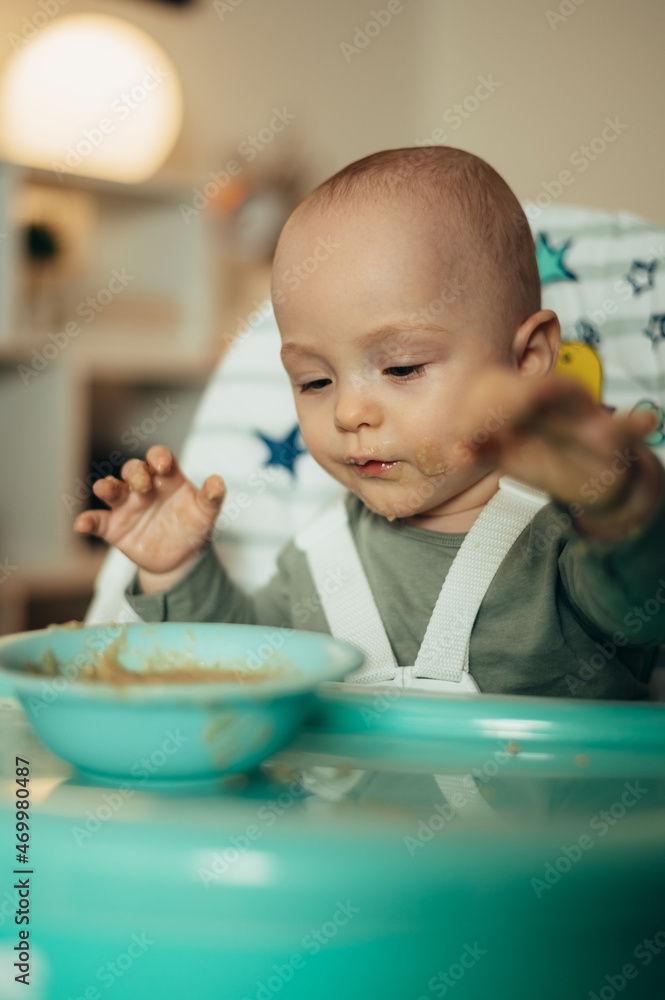 Adorable little baby eating his dinner and making a mess Adorable little baby eating his dinner and making a mess