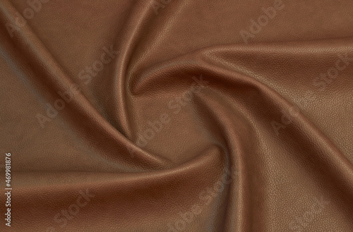 brown artificial leather with waves and folds on PVC base