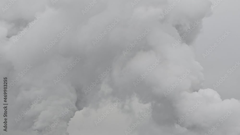 White steam from pipes against a cloudy sky close-up White steam from pipes against a cloudy sky close-up