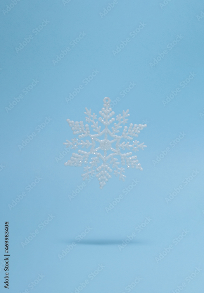 creative Christmas snowflake with sunny shadow against pastel blue background. minimal modern surreal creative idea with copy space. modern new year futurism concept creative Christmas snowflake with sunny shadow against pastel blue background. minimal modern surreal creative idea with copy space. modern new year futurism concept