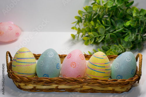 easter eggs in a basket on the grass