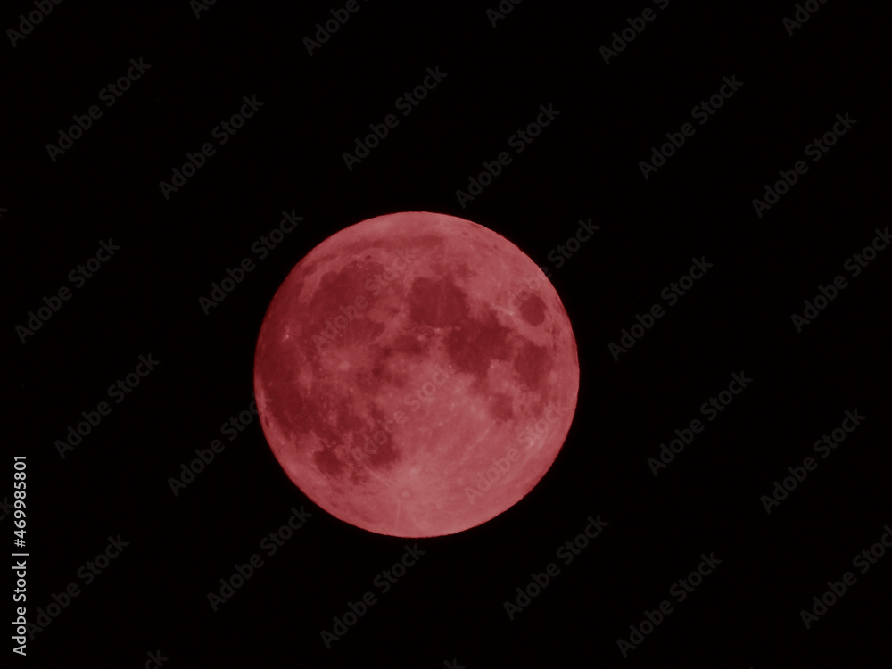 Obraz premium An amazing photography of the full moon over the city of Genova by night with a great clear and blue sky in the background and some stars. Rendering in different colours.