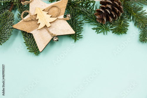 New Year's background. Christmas decorations and fir branches on a blue background. Top view.