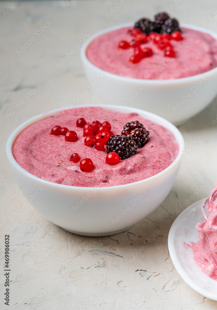 A healthy pudding of semolina and currant with blackberries served in a white bowl. A healthy pudding of semolina and currant with blackberries served in a white bowl.