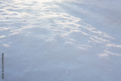 Fresh snow texture background in blue tone and sunlight.