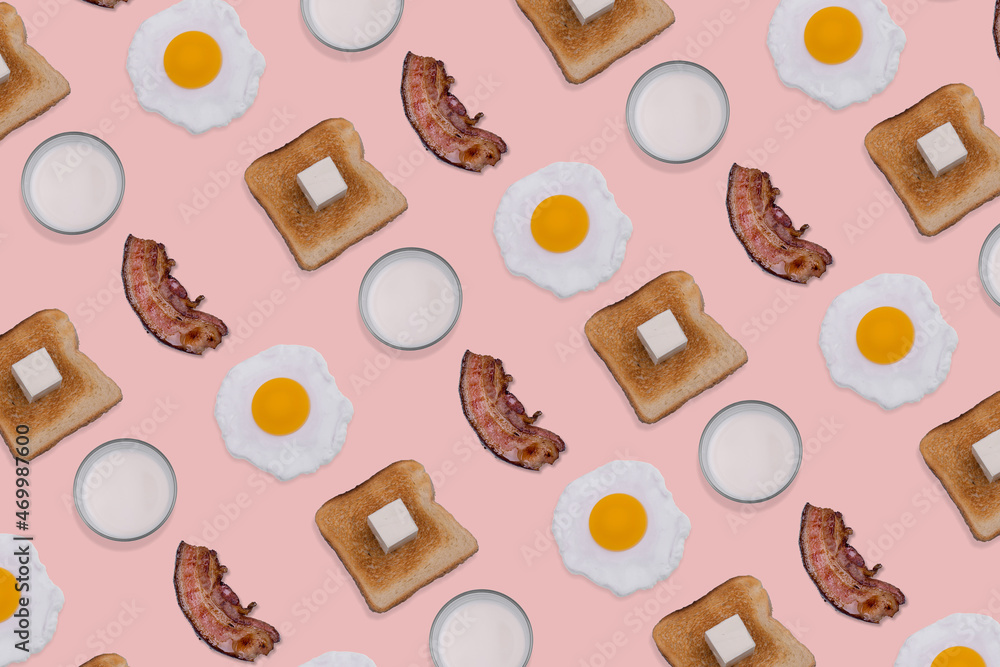 Pattern made with slices of crispy bacon, fried eggs, toast bread and glasses of milk on pastel pink background.