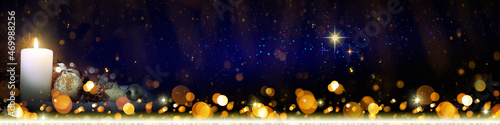 Advent candle and christmas decoration in atmospheric light.