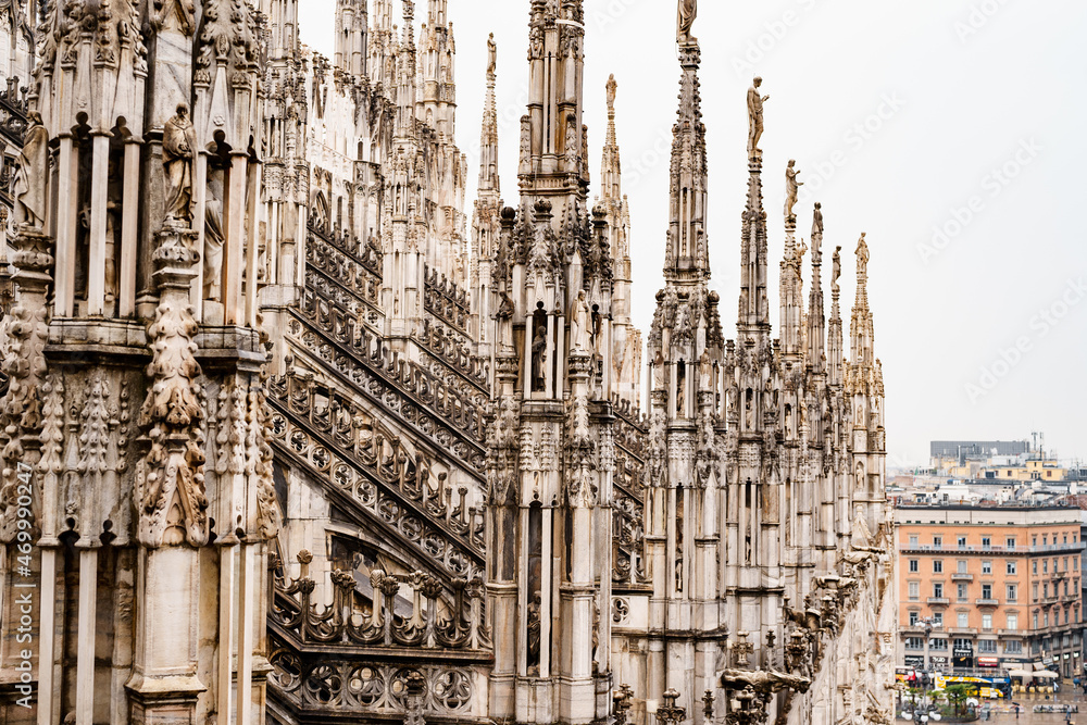High spires with sculptures on top in the Duomo. Milan, Italy