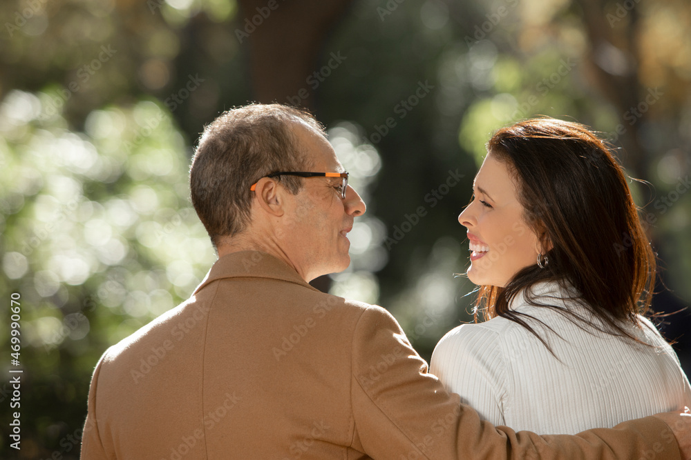 Fototapeta premium mature couple outdoors looking at each other with laughter