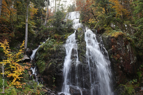 The beautiful 32m high Grande Cascade de Tendon  in autumn. The three-tiered waterfall is a scenic tourist attraction in the Haut Vosges area of eastern France.