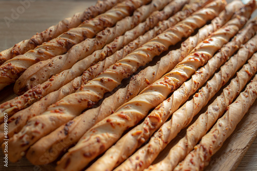 Italian bread sticks. Grissini with cheese and spices. Dry loaf. A traditional dish of the Piedmont province. Thanksgiving Day. How to replace bread. Flour dish. Party snacks.