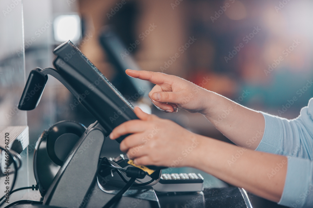POS concept, young woman hand doing process payment on a touchscreen cash register, finance, shopping