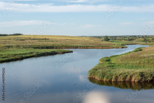 rural landscape of a field with a river on the background of a cloudy sky august ukraine