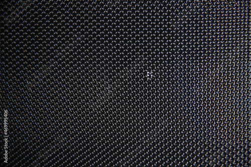 Macro shot of speaker grille. Vintage effect. Close up shot of a round speaker. Acoustic broadband speaker. Luxury car stereo system speaker. Holes in a metal lattice. photo