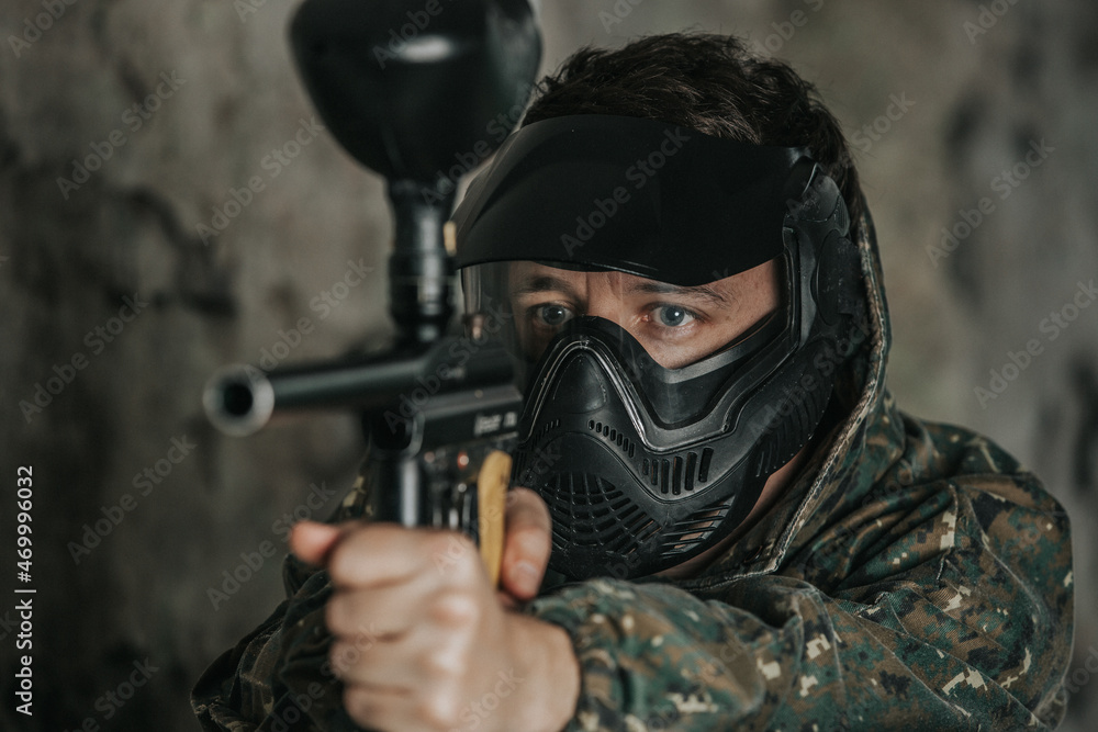 Portrait of paintball player, game in which participants simulate military combat using air guns to shoot capsules of paint at each other, sport concept