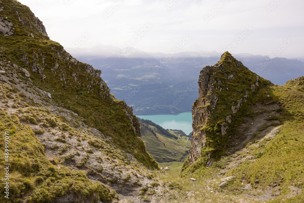 Fototapeta premium Amazing hiking day in the alps of Switzerland. Wonderful view over a beautiful lake called Brienzersee. What an amazing view.