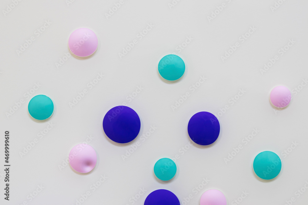 Beautiful drops of aqua, pink, and purple acrylic paint float in oil