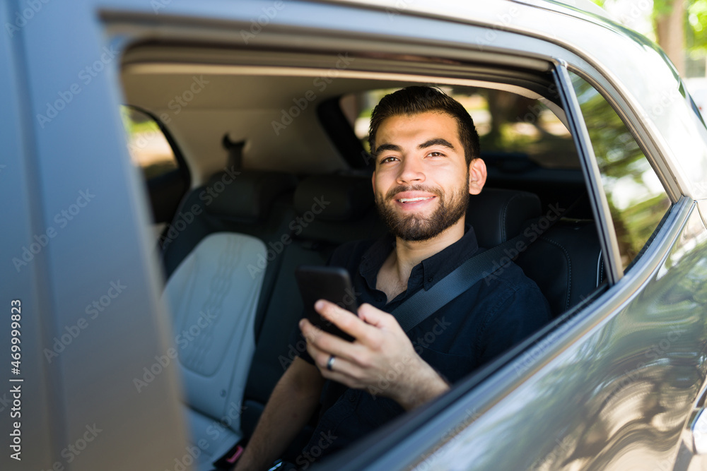 Cheerful passenger using a rideshare app Cheerful passenger using a rideshare app