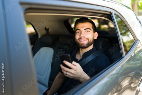 Cheerful passenger using a rideshare app