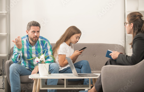 parent-teacher meeting. parenthood and fatherhood. kid and dad talk to social worker.