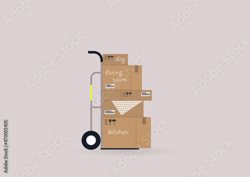 A moving out scene, a cart with a stack of cardboard boxes on it