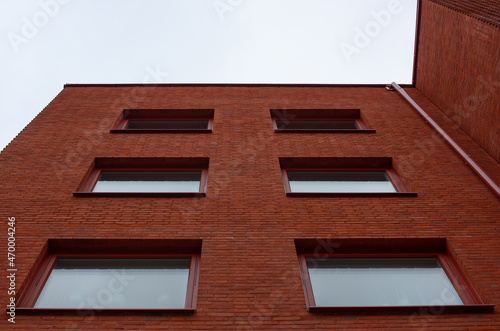 M?lndal, Sweden - October 09 2021: Looking up a red brick apartment building. photo