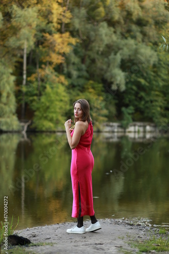 Woman in red dress near the lake