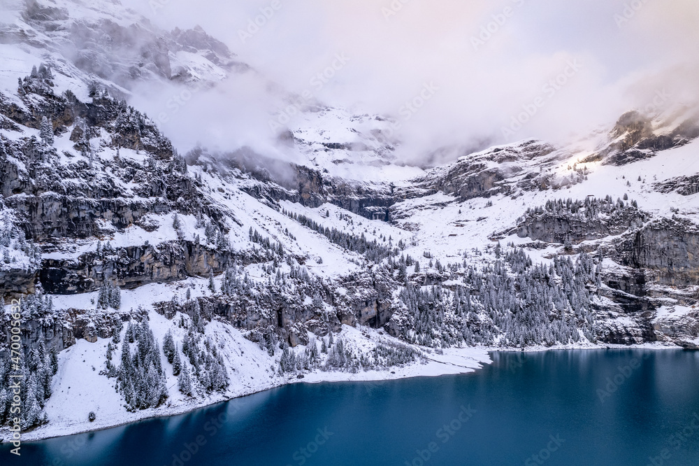 Oeschinensee Lake in Switzerland Surrounded by Snow Covered Trees and Mountains