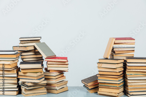 stacks of educational books in the college library on a white background