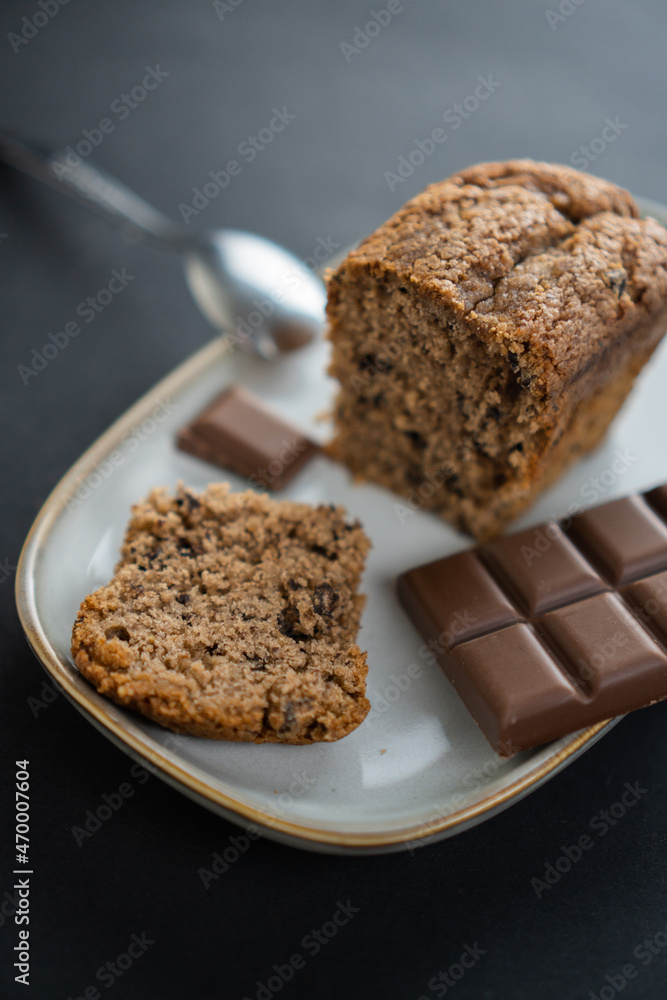 food photography: a small piece of cake on a stylish plate with a piece of chocolate