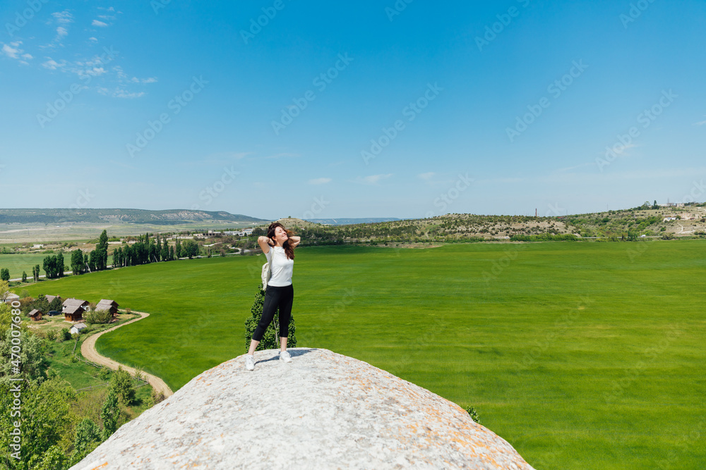 woman traveler walking on top of the mountain woman traveler walking on top of the mountain
