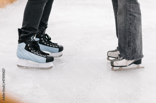 Young couple holding their hands in and figure skating foot shot