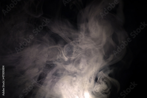 vague puffs of smoke on a black background