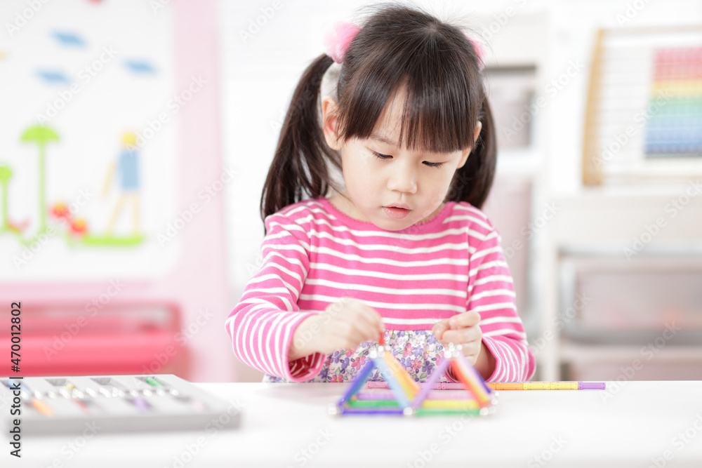 young girl playing creative 3d shape toy for homeschooling young girl playing creative 3d shape toy for homeschooling