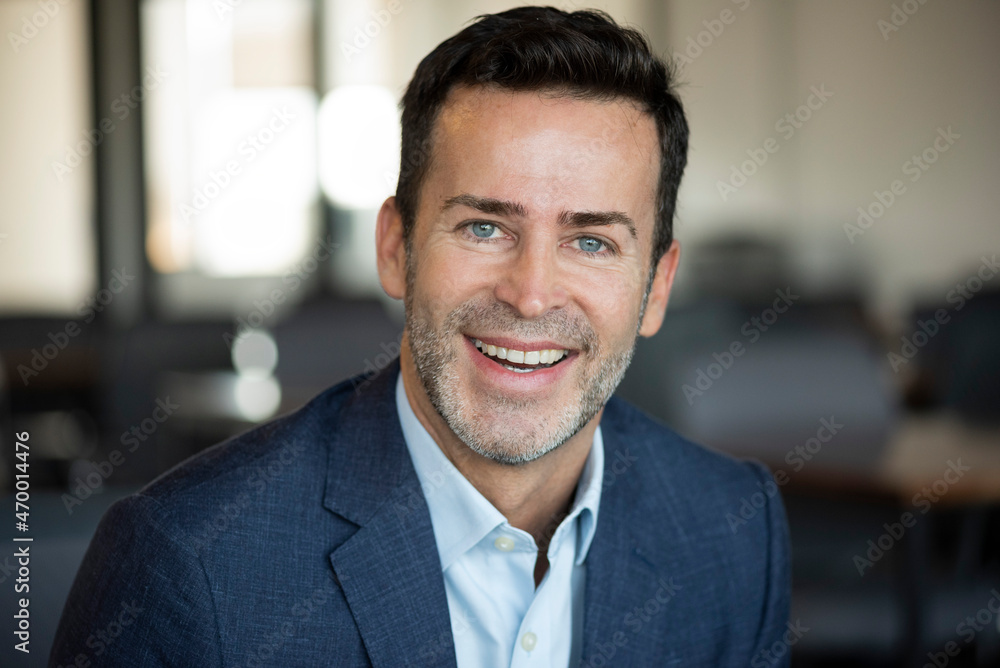 Portrait of smiling businessman in office Portrait of smiling businessman in office