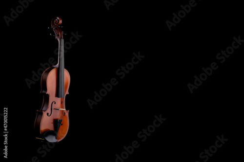 A wooden violin or viola on a black background photo