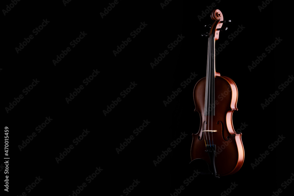 A wooden violin or viola on a black background A wooden violin or viola on a black background