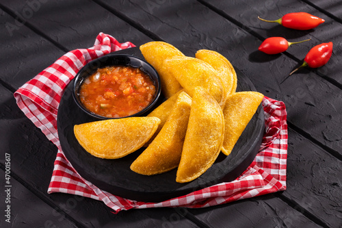 Fried empanadas with spicy sauce - typical Colombian food photo