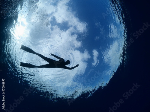 free diver snorkeling on the surface sky clouds underwater lady woman freediver
